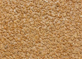 Wall finish in mustard colour with exposed matching mustard aggregates