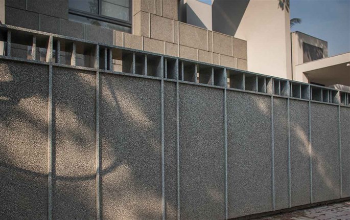 Grey stonecrete exposed aggregate plaster finish on bungalow walls