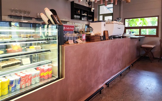 Interior of a Surat café with FF MicroCement flooring, highlighting its sleek, joint-free design