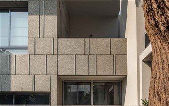 Grey stonecrete exposed aggregate plaster finished bungalow walls