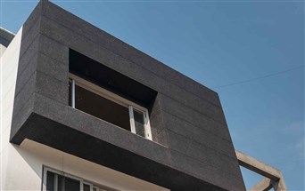 Black stonecrete grit plaster walls on the exterior walls of a bungalow