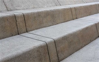 grit washed exposed plaster in grey shade on steps by freeform